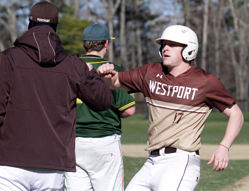 Connor James celebrates with a coach after hitting a run-scoring single during the Wildcats 10-2 win over Shore Shore on Wednesday afternoon.&nbsp;