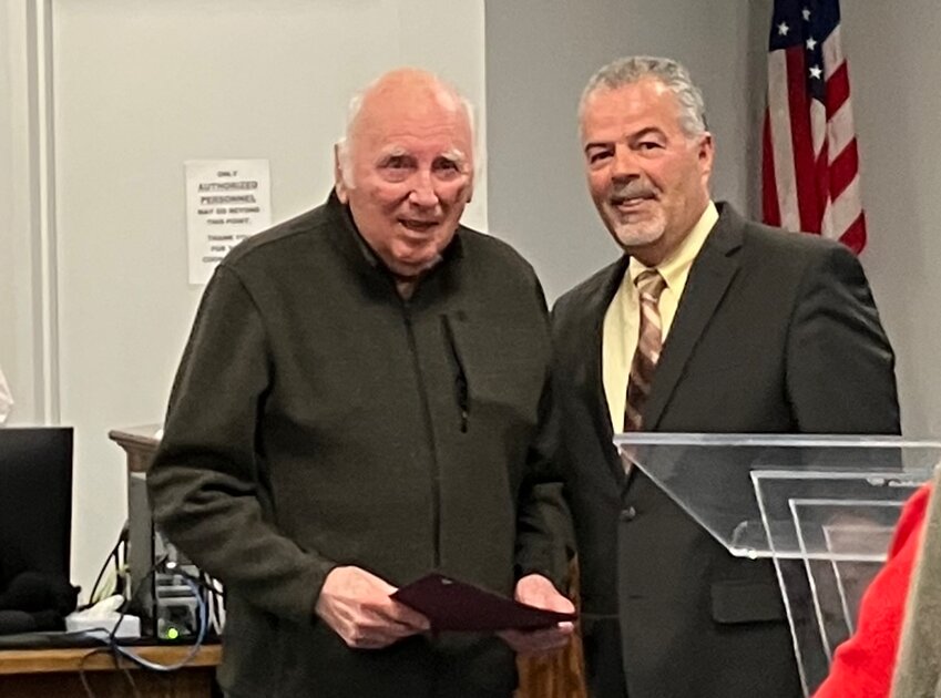 Former councilor and long-time community contributor Ed Theberge (left) was honored by the town council, including current member Louis Rego, at the body's April 8 meeting. Theberge will soon move from Warren.