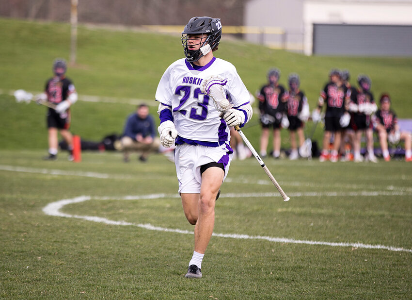 Aidan Pereira holds possession for the Mt. Hope High School boys' lacrosse team in its 12-2 victory earlier this week over visiting Providence Country Day. Pereira was dominant in the face-off circle as he and the Huskies remained undefeated in Division III play.