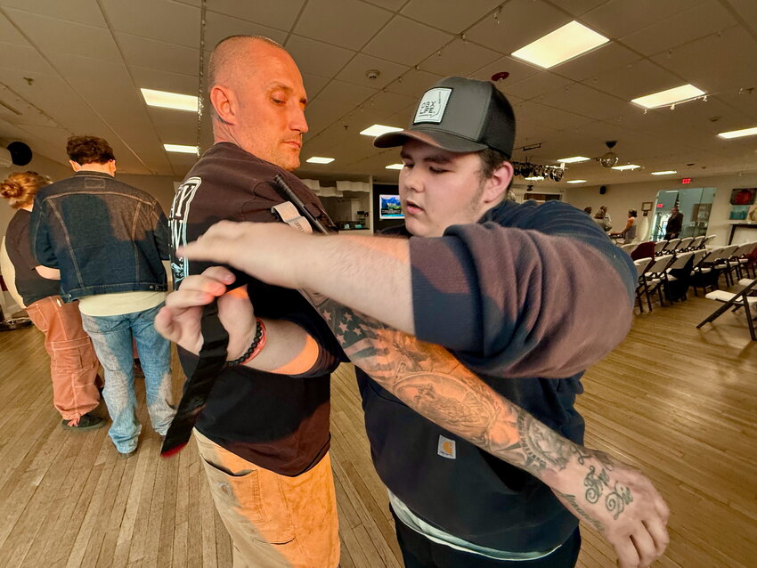 Nathan Mathias (right) applies a tourniquet to Jason Helger of Tiverton during a &ldquo;Stop the Bleed&rdquo; training session that Mathias organized last week at the CFP Arts, Wellness, and Community Center in Common Fence Point.