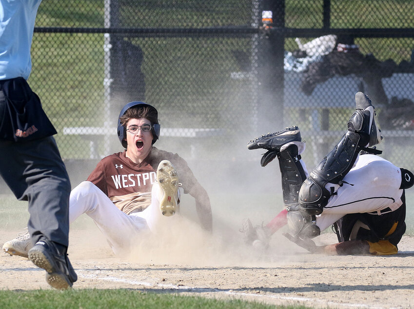 Jacob Aurelio slides under the tag of the Boston International catcher and scores the winning run for the Wildcats in the third inning.&nbsp;