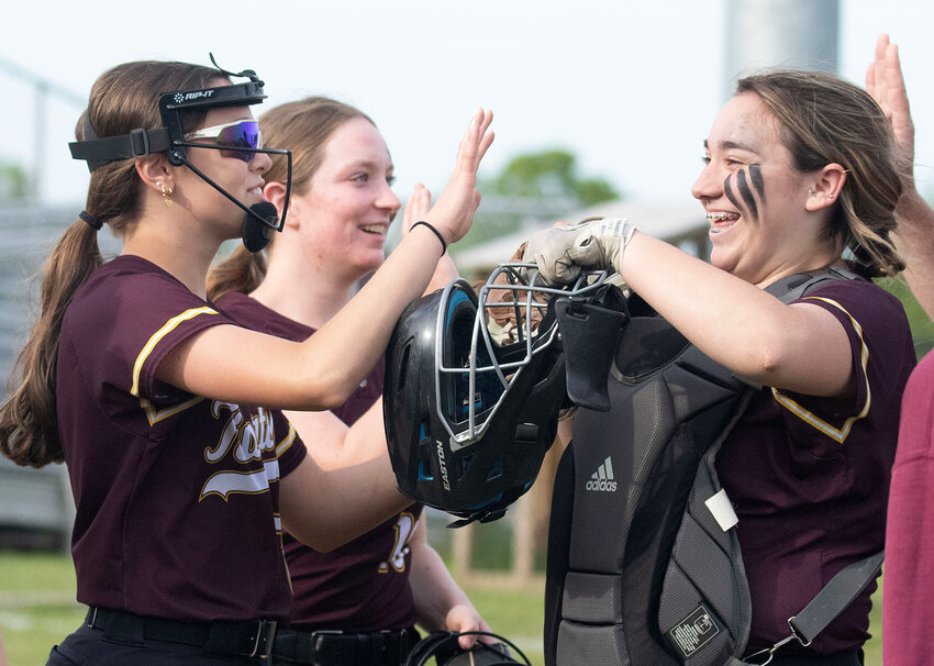 Pitcher Lia Doster (left) and first baseman Carlie Martin (middle) high five catcher Lexi Boissonneau after she caught a foul ball during the Tigers 11-2 win over Pawtucket in the Div-3 winner's bracket quarterfinals on Tuesday afternoon.&nbsp;  Tiverton also beat Narragansett 21-13 in the semifinals setting up a winner's bracket final against Cranston East on Monday night.&nbsp;