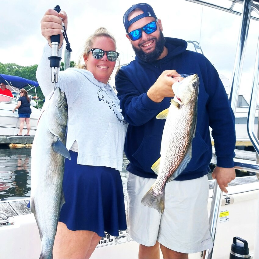 Sherri Kanelos with bluefish and Marc Carvalho with a squeteague, both of Warwick, planned to bake and eat their catch whole Sunday night.&nbsp;