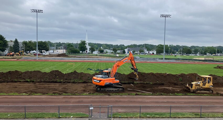 Workers begin digging up the Victory Field playing surface on Monday morning, June 9. Plans call for a new track and artificial turf multi-sport field.