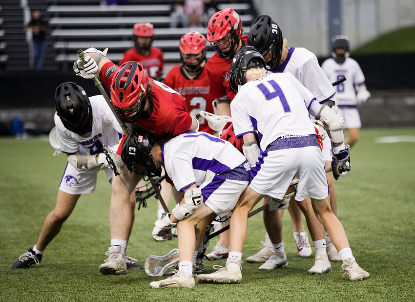 Mt. Hope and Narragansett players scramble for a loose ball during the teams' Division III championship game Monday night, June 9, won in an upset by the Mariners over the top-seeded locals.