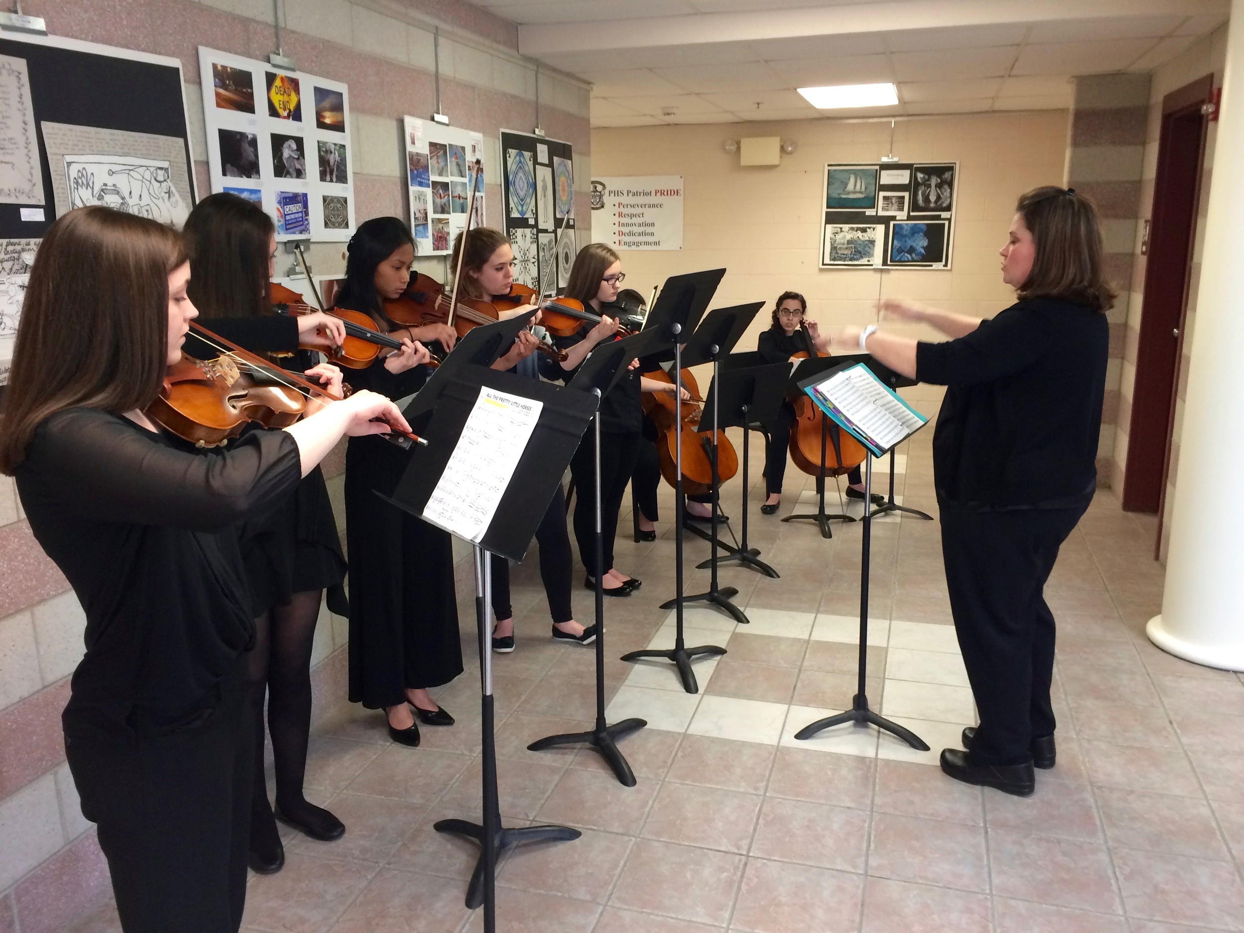 The PHS strings ensemble performs prior to an opening program on Sunday. The PHS vocal ensemble and actors in the upcoming school production of the musical “Grease” also performed.