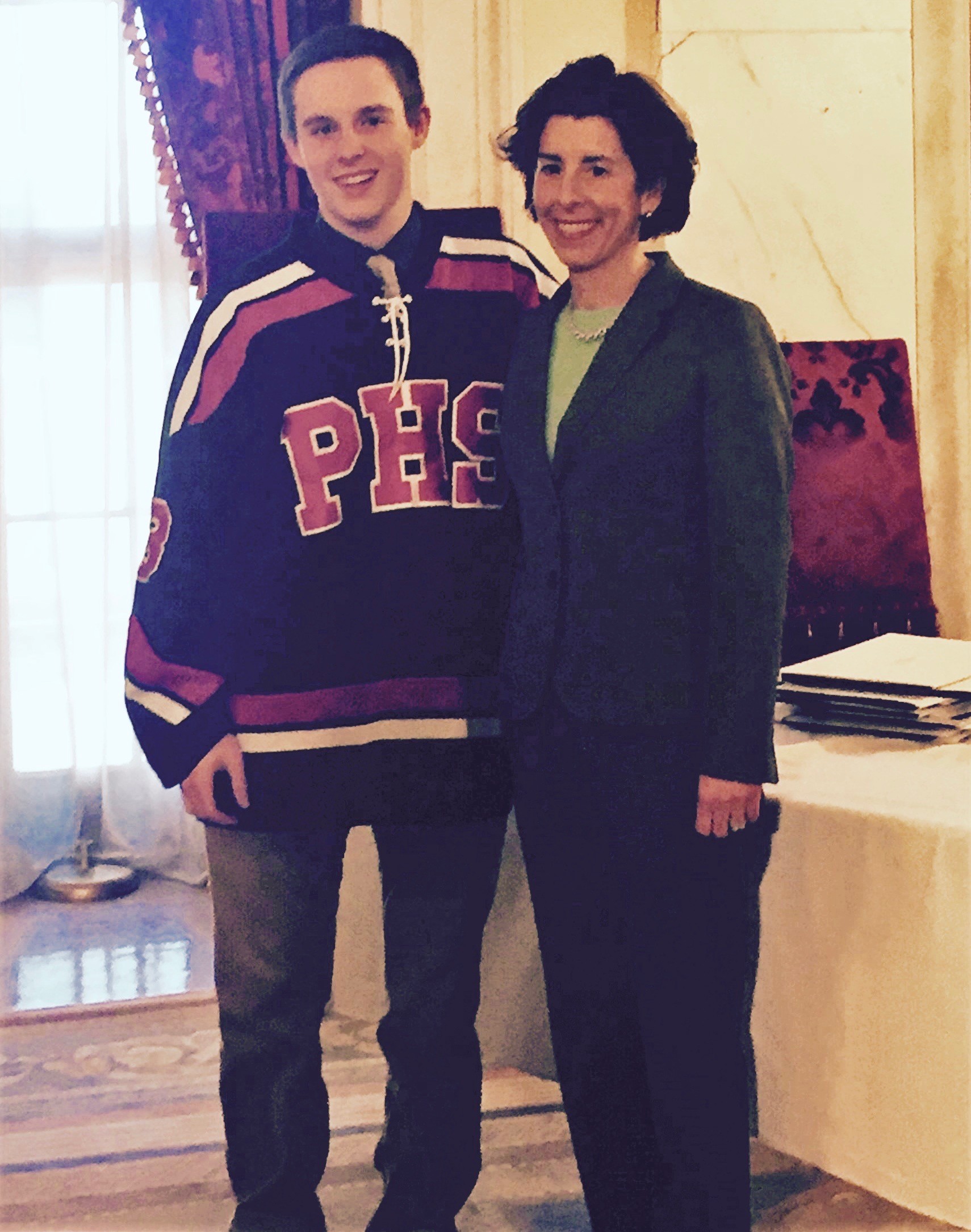 Aidan O’Brien with Gov. Gina Raimondo during an awards ceremony at the State House on Tuesday. Aidan was named the Hobey Baker High School Award winner for Portsmouth High School.