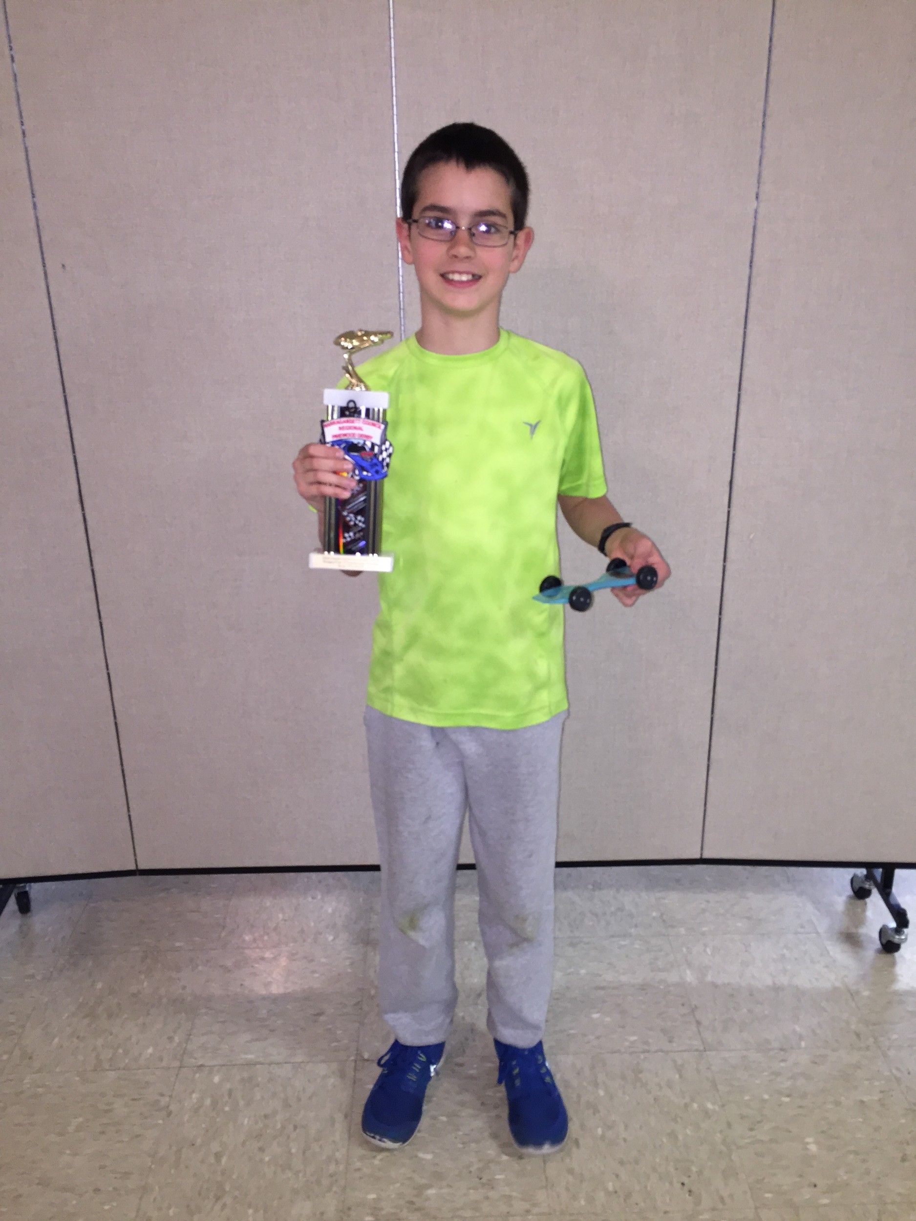 Gio Perrotti of Pack 82 Portsmouth poses with his second-place trophy and car.