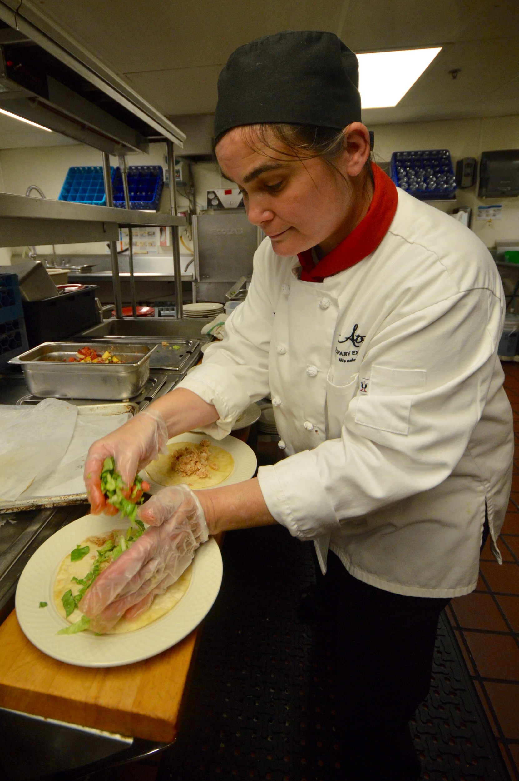 Atria Chef Alisa Onorato prepares her codfish tacos for the judges.