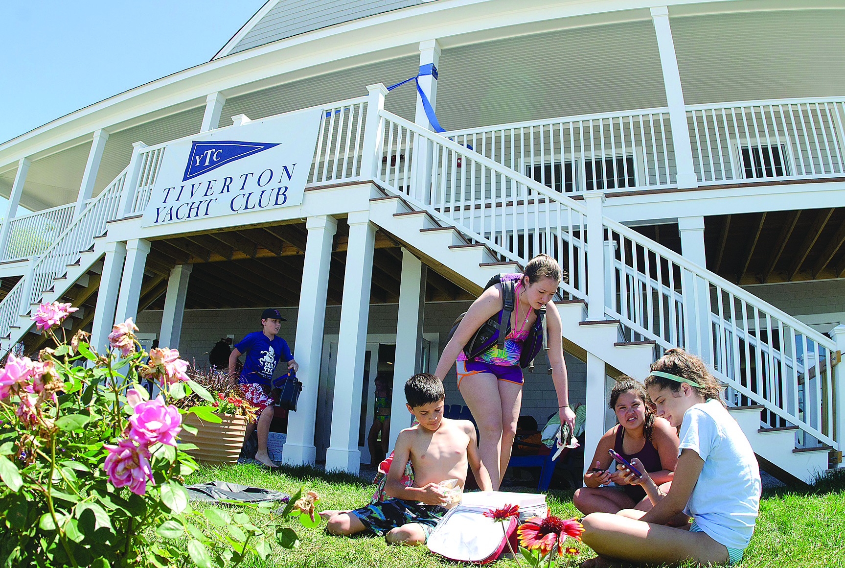 Youngsters take a sailing program lunch break in front of the new Tiverton Yacht Club clubhouse last week.