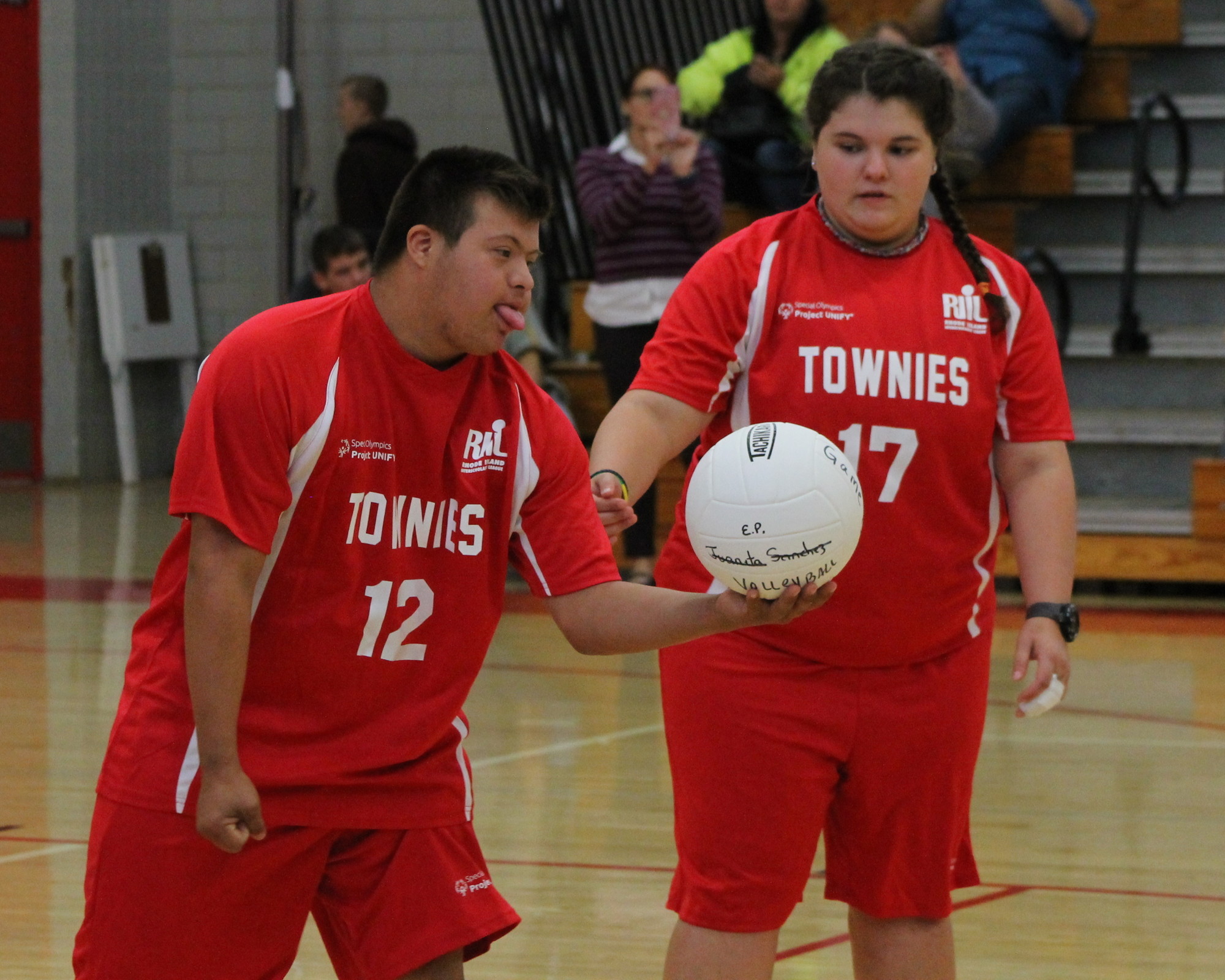 EPHS Unified Volleyball athlete Jonah Wagner readies to serve under the watchful eye of partner Tianna Delsantos.