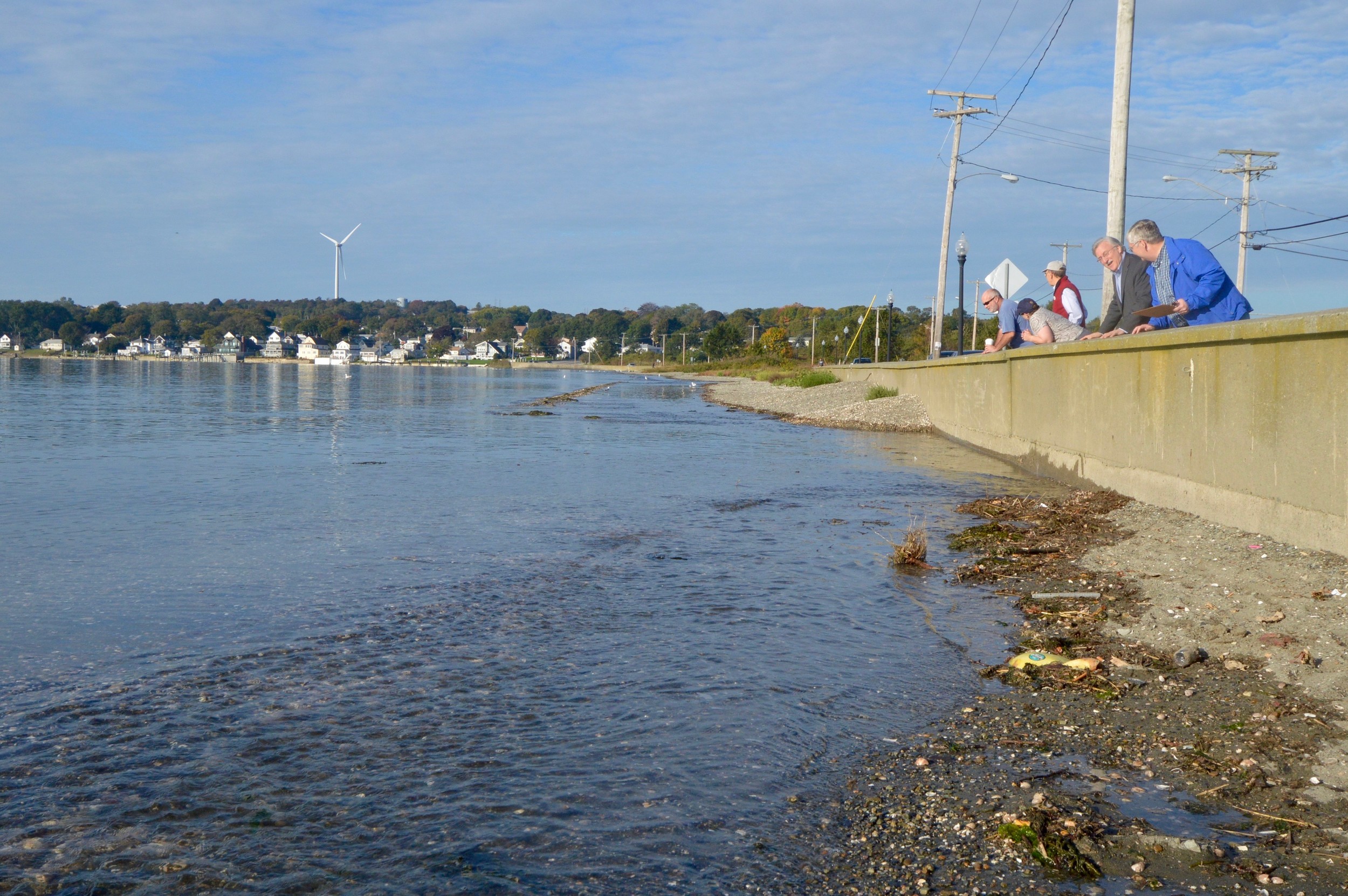 Curious onlookers — including some candidates running for office — gather at the Island Park seawall along Park Avenue to inspect the five-foot “King Tide” that occurred Monday morning. Town planners say the condition will occur much more often by 2035/2040 — on nearly a third of the days of the year.