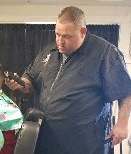 Jesse Rego working at Upper Cuts Barber Shoppe (shop website photo)