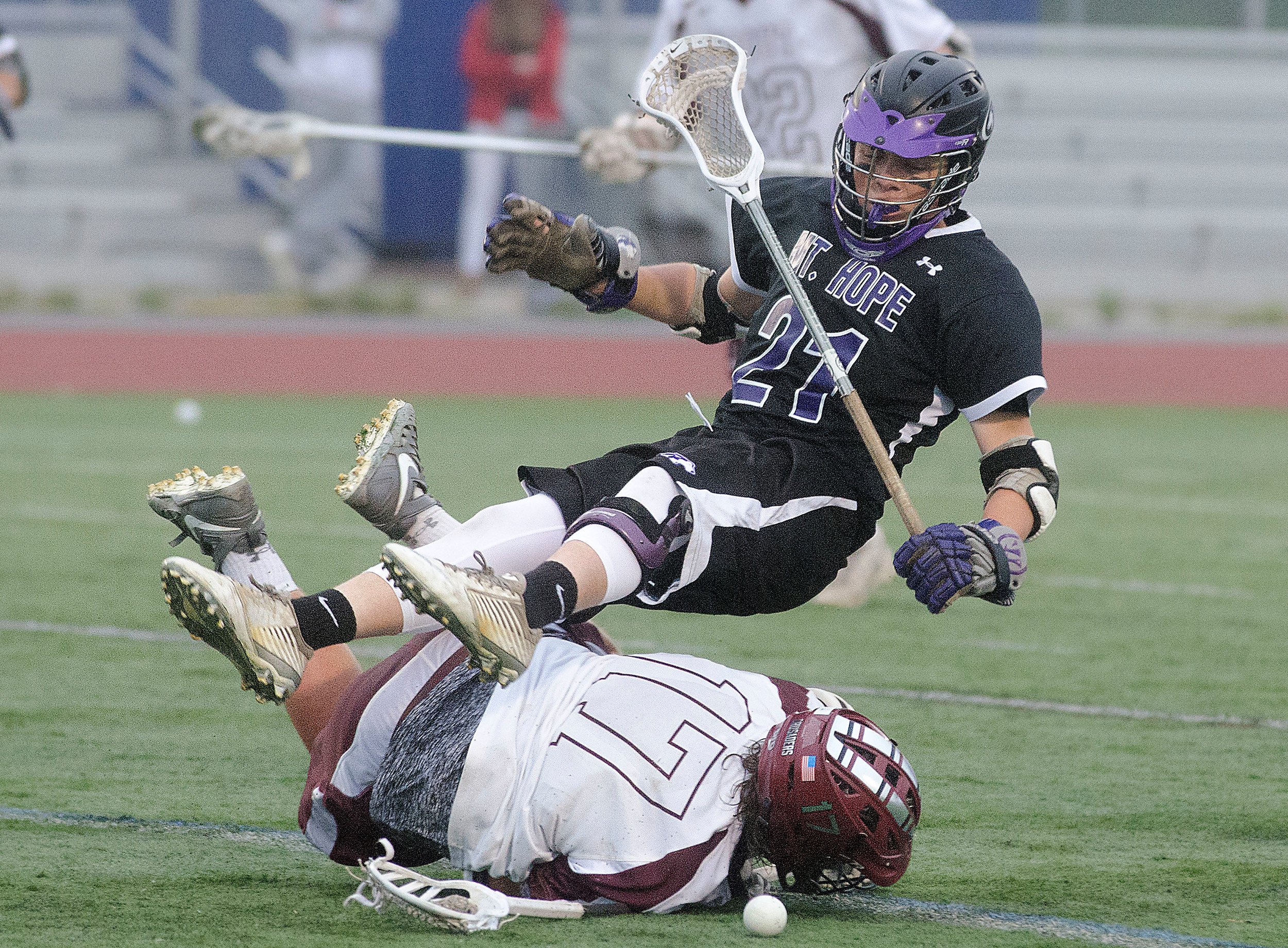 Huskies attacker Stephen Serbst takes a low hit from Prout's Christian Fonseca while playing a loose ball.
