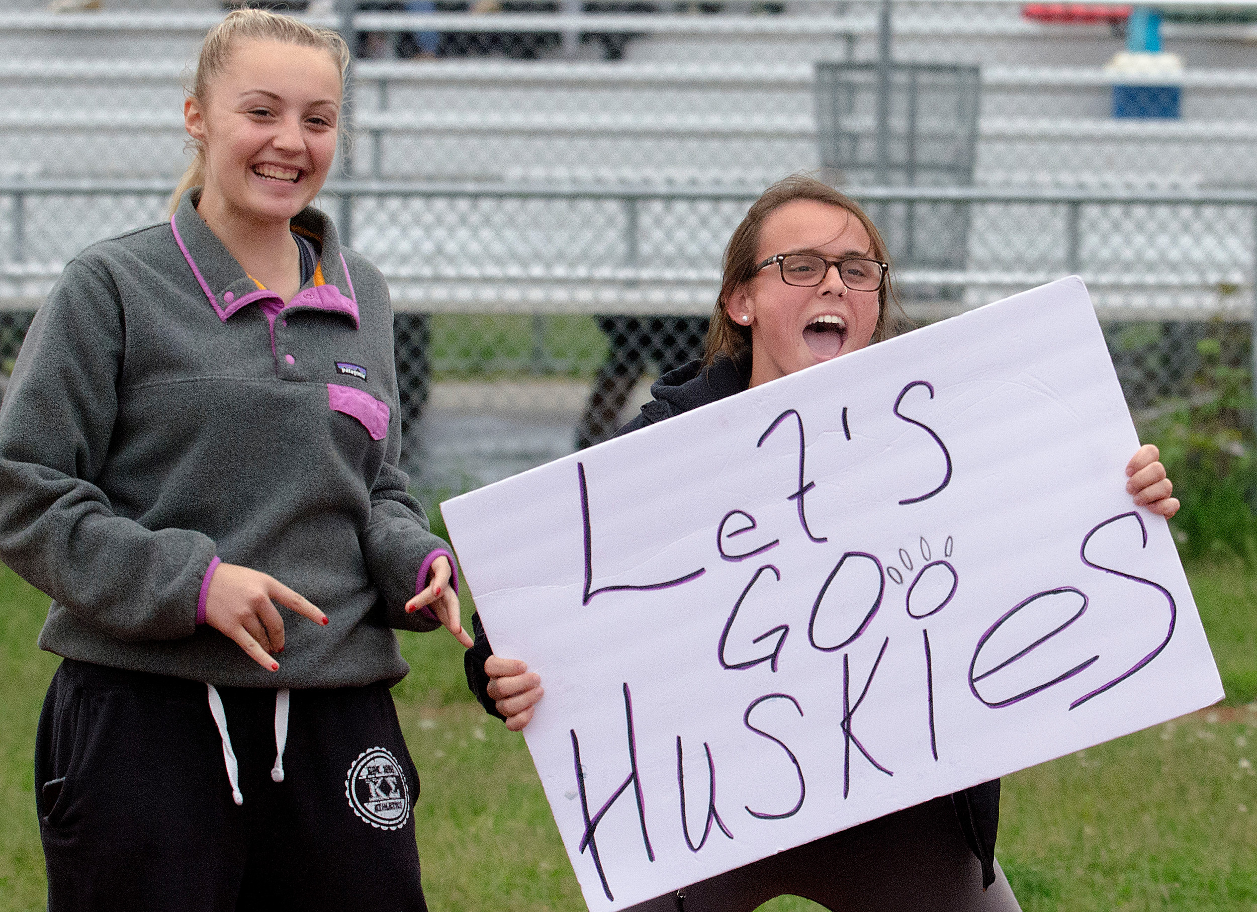 Girls lacrosse team members Jenna Cimbron and Alyssa McGreevy cheer on the Huskies.