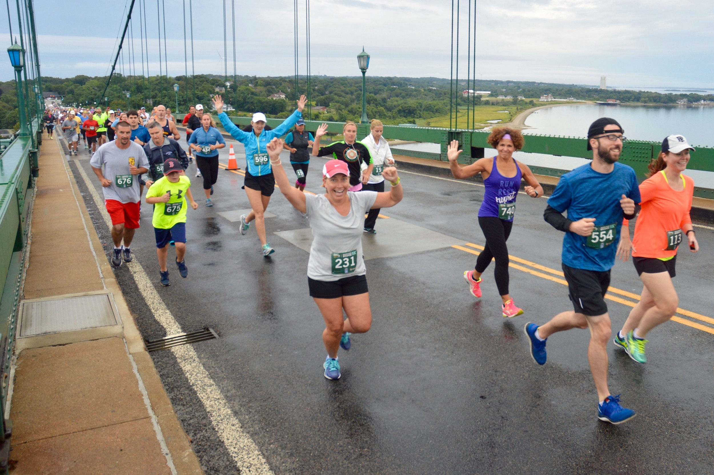 Runners head over to Bristol during the inaugural Mt. Hope Bridge 5K Road Race. Portsmouth is in the background, with the Carnegie Abbey Tower seen in the distance at right.