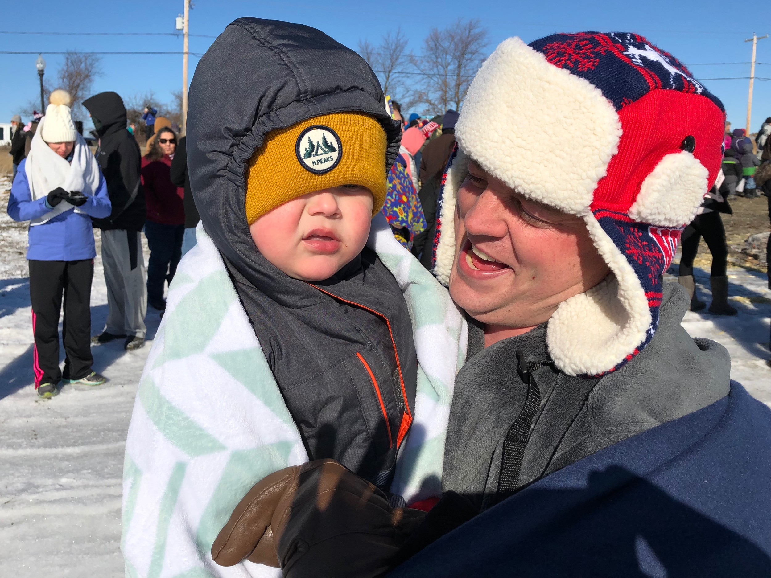 Before running in, Blake Hayden holds 2-year-old Wesley Murray, his girlfriend’s son. “He wants to jump in,” said Mr. Hayden.