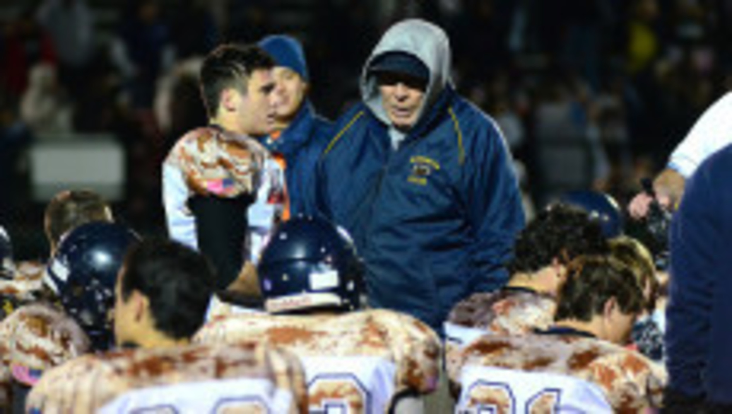 Barrington High School football coach Bill McCagney talks to his team after a regular season game last year.