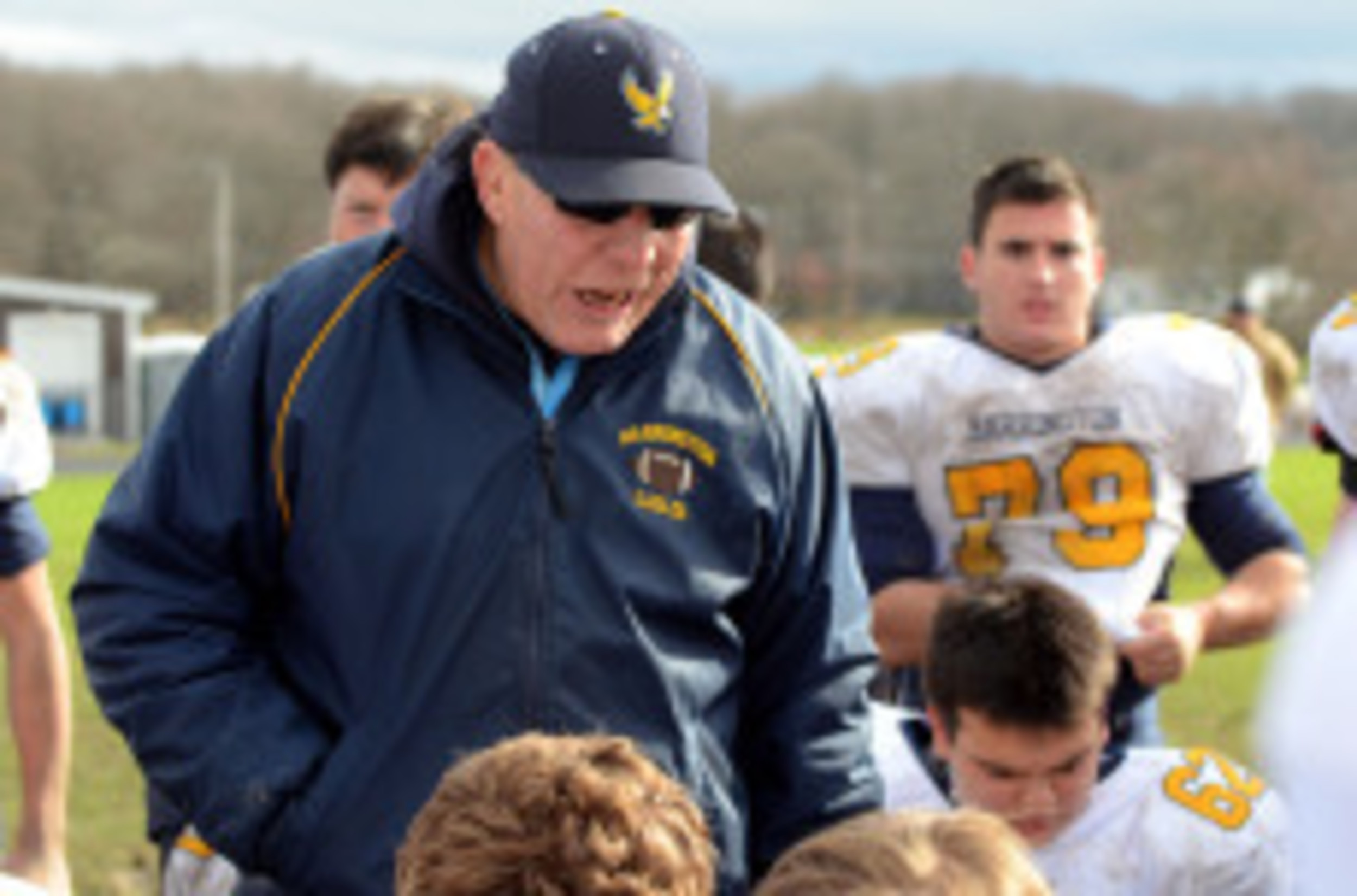 Barrington High School football coach Bill McCagney talks to his team after a regular season game last year.