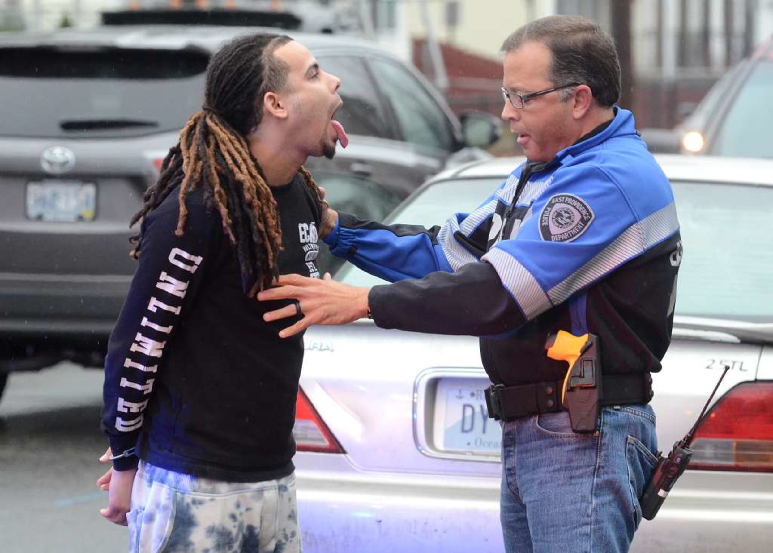 Photo by Rich Dionne
EPPD Vice Sgt. Diogo Mello checks Luis Espinal, 23, (left) for drugs during a heroin bust in December. Espinal was one of several dealers arrested in the department's recent investigation in the sale and purchase of heroin in the city.