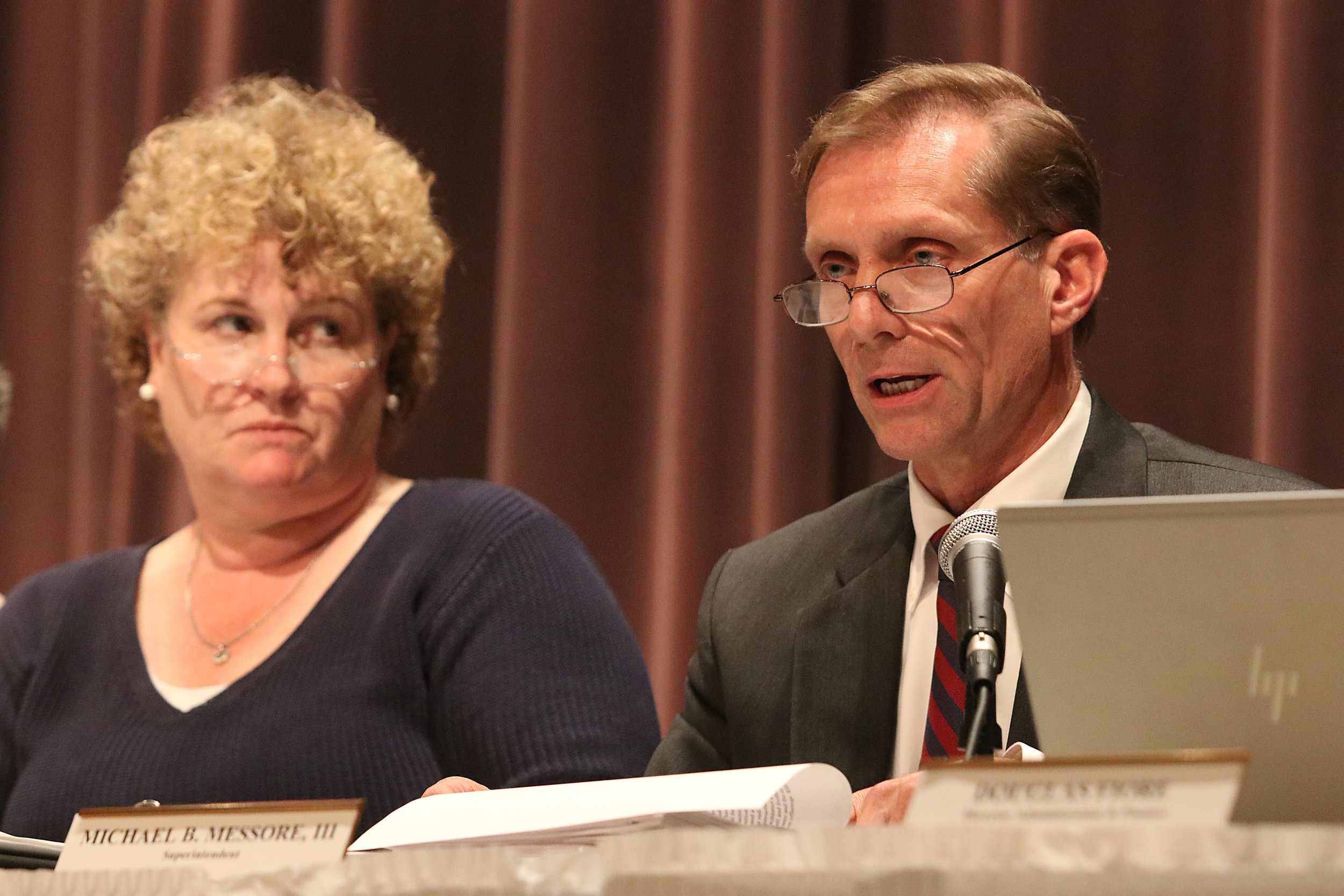 Barrington Superintendent of Schools Michael Messore answers a question from the audience during a public hearing earlier this year. School Committee member Anna Clancy looks on.