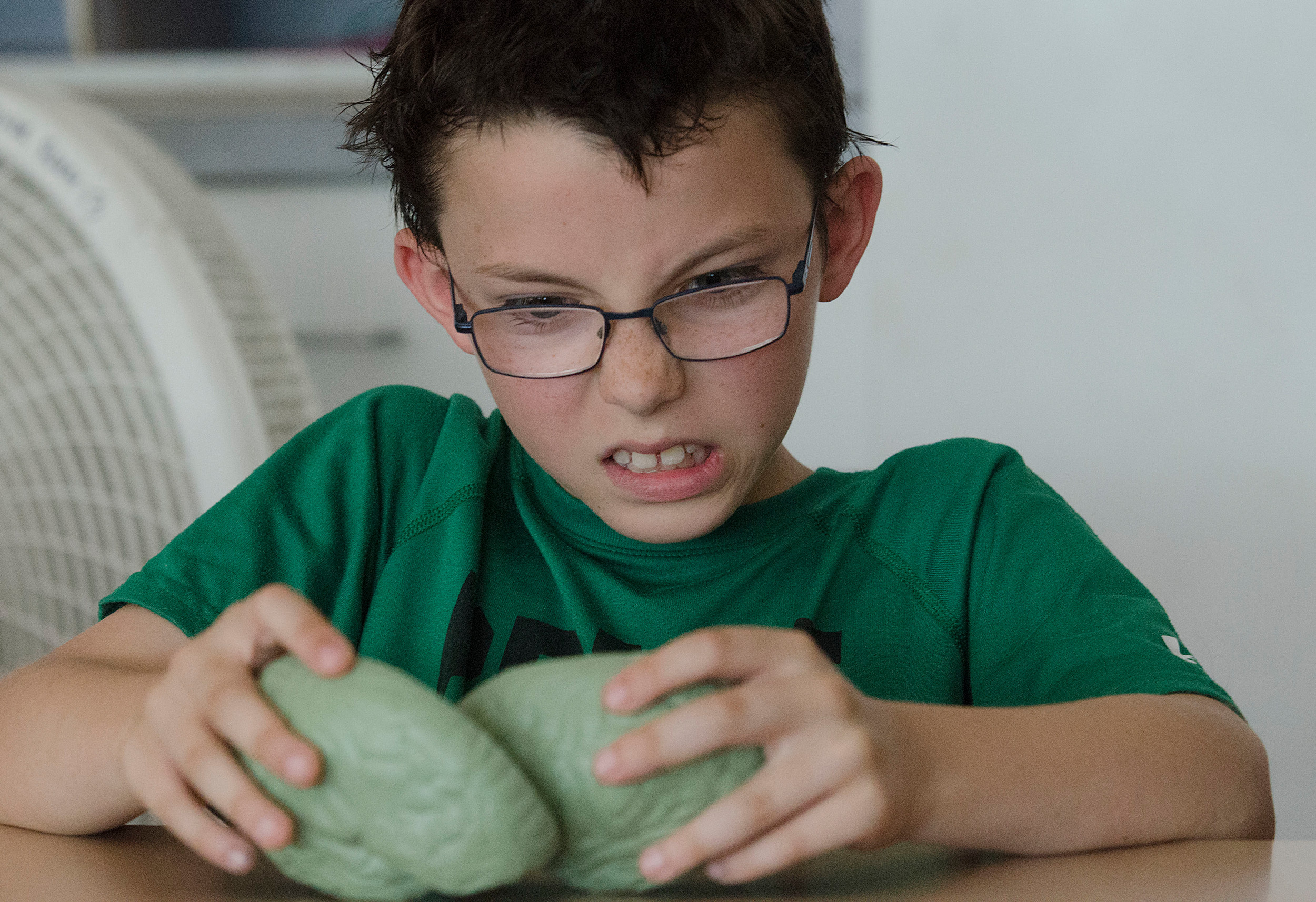 A Sowams School third-grader plays with a model brain during a recent BrainStation program at the school.