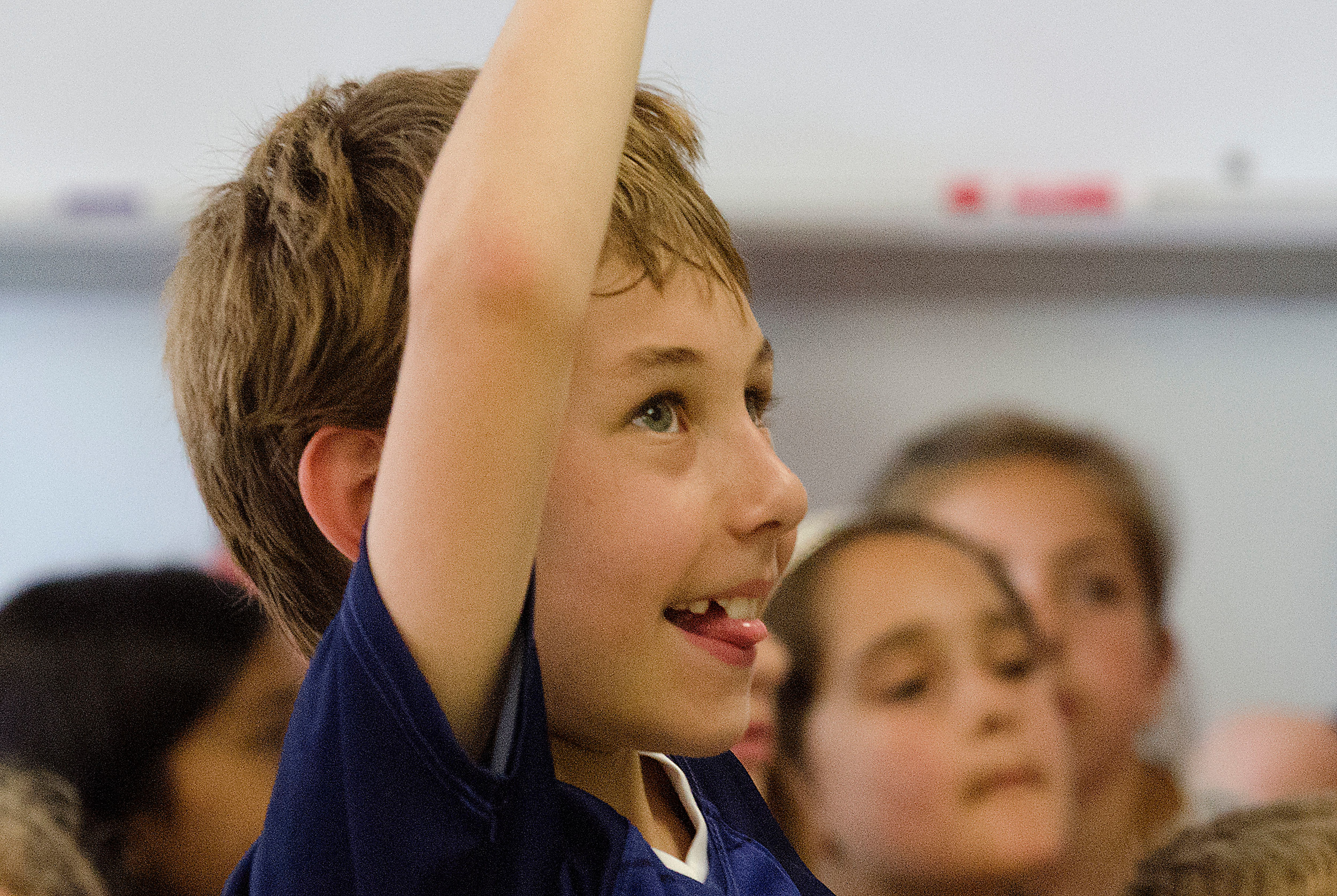 A Sowams School student raises his hand, ready to answer a question posed by BrainStation's Dr. John Stein.