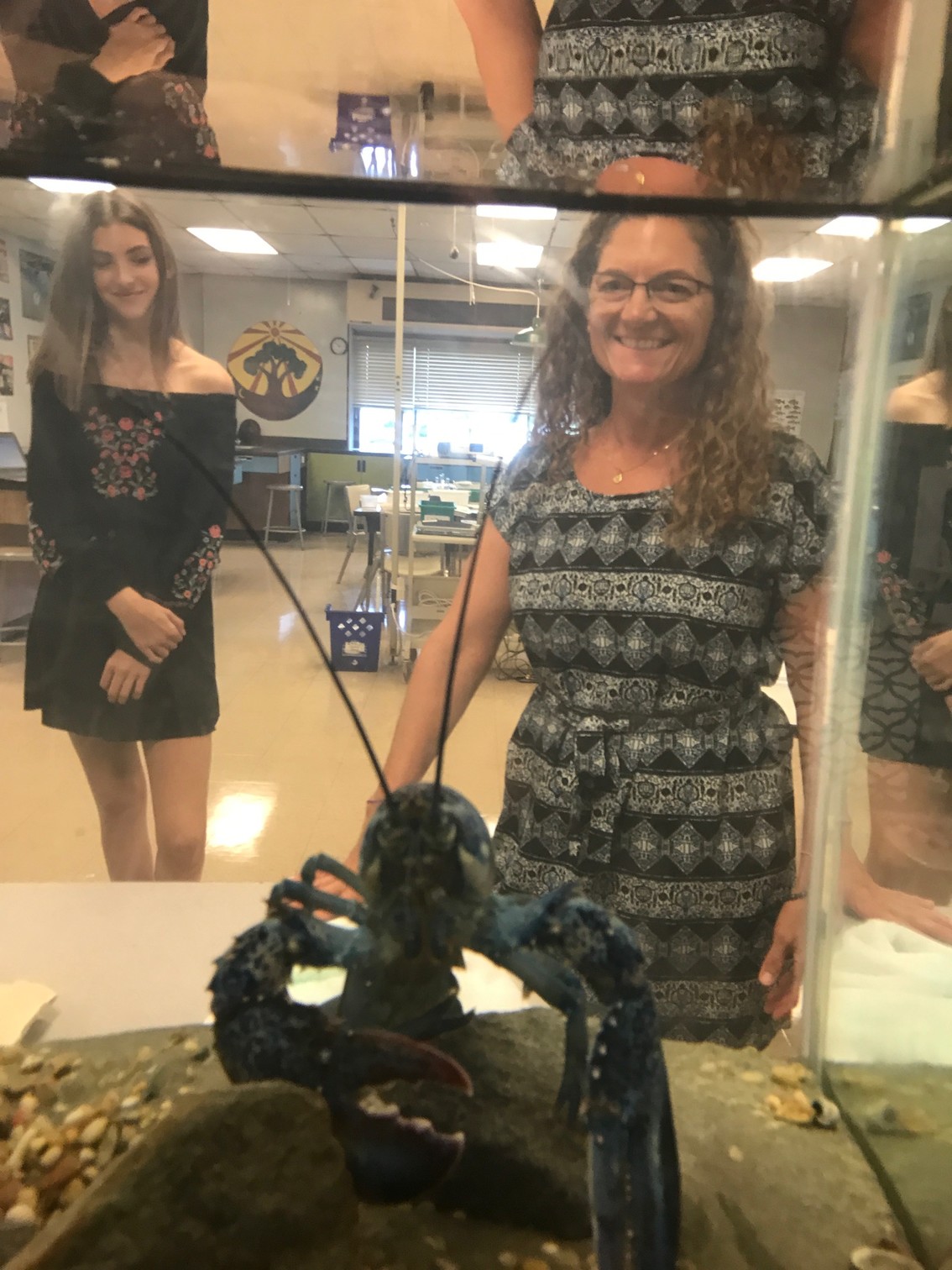 Portsmouth Middle School science teacher Dana Reed watches the new (and temporary) classroom inhabitant.