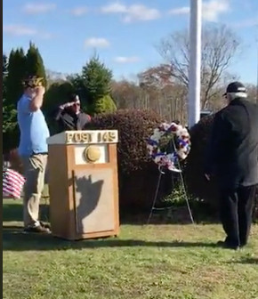 Antone Vieira Jr., right, salutes a wreath honoring Westport’s veterans. At left is Veterans Services Agent Bradford Fish.