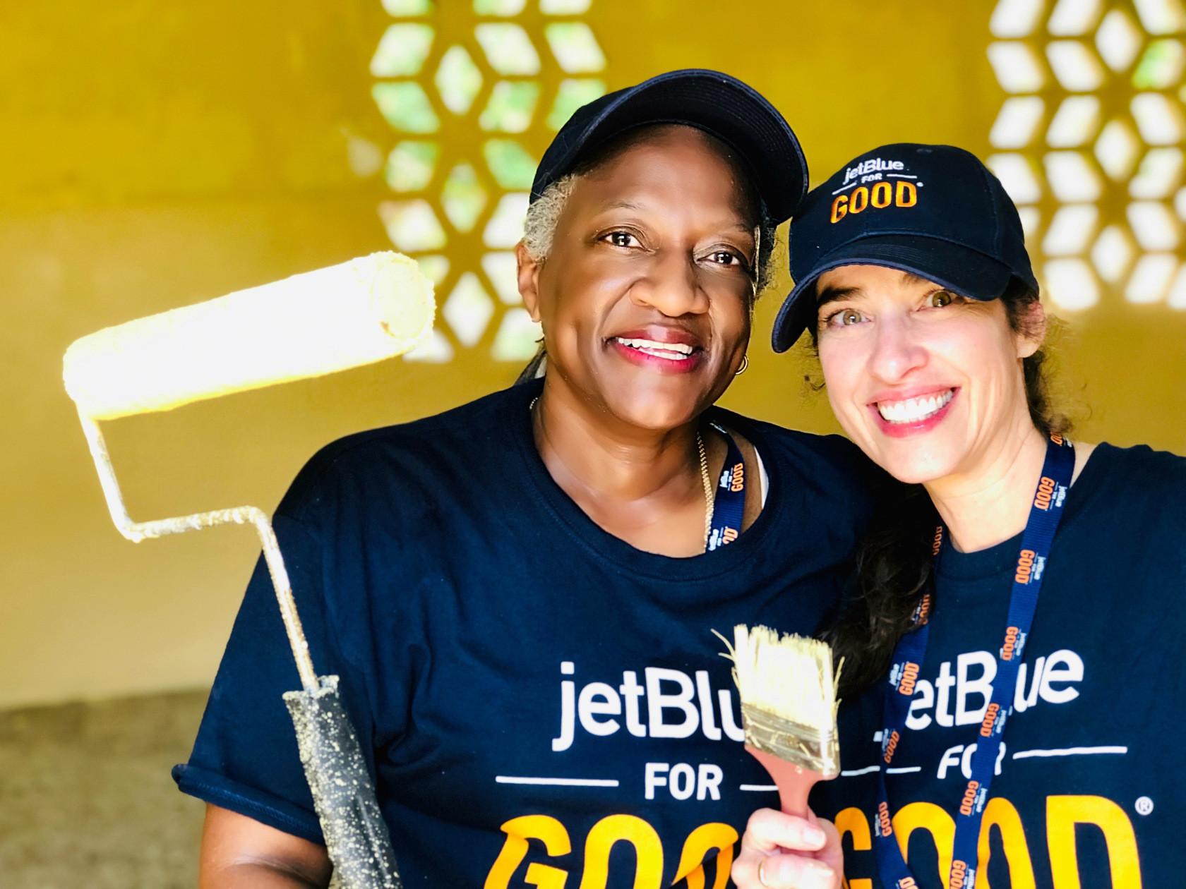 Mattie Kemp (left) and Maria Takacs of Pennfield School take a quick break for a photo while painting the interior of a classroom in the Dominican Republic. Ms. Takacs won a service trip through a JetBlue for Good essay contest, and took Ms. Kemp along with her.