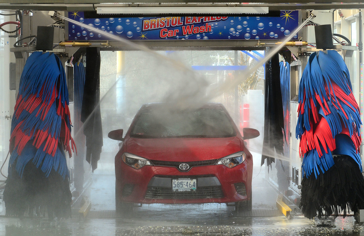 A customer and her passenger ride along while in the Bristol Express car wash on Metacom Avenue on Thursday.