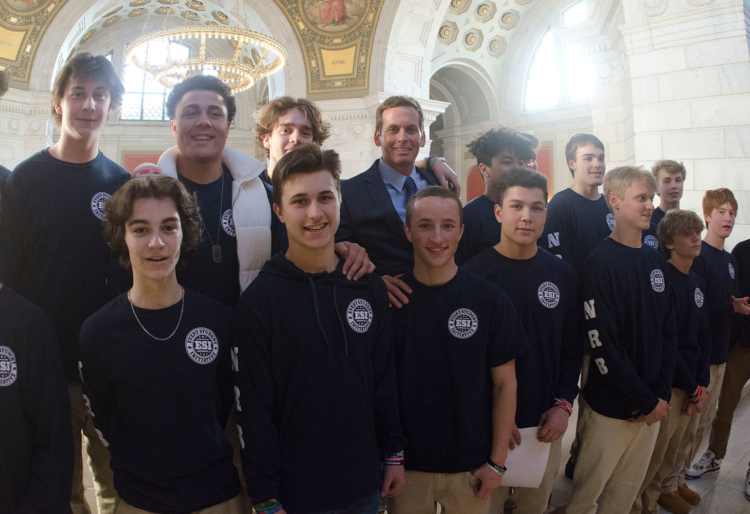 Every Student Initiative members pose for a photo in a hallway at the State House before a Senate subcommittee hearing.