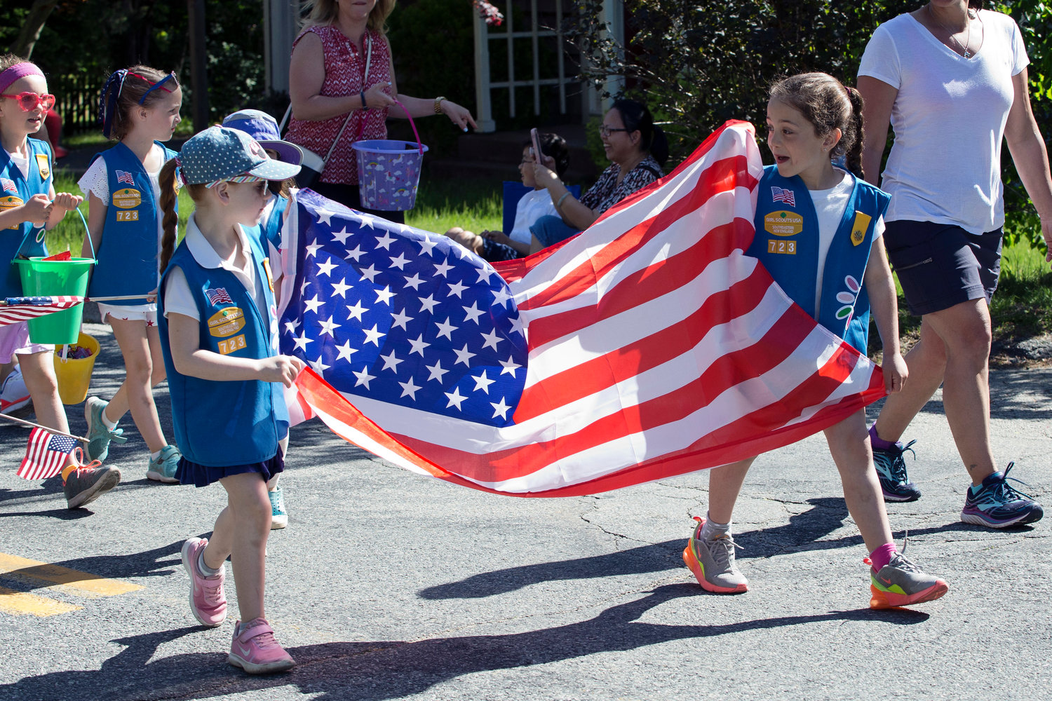 Members of Barrington Daisy Troop 723 carry an American flag through the Memorial Day parade route a previous year.