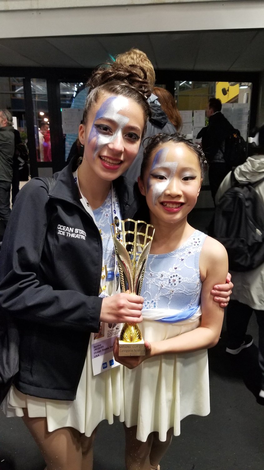 Barrington residents Santina Jacques (left) and Iris Yang pose for a photograph with the second place trophy at Nation's Cup International Figure Skating Competition, held in France.