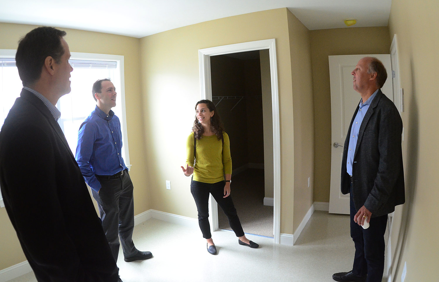 Shawn Martin, Brian Kortz and Christina Viera of Fuss and O'Neill and architect Paul Attemann of Union Studio (from left to right) check out a one bedroom apartment at Palmer Pointe during a special ribbon-cutting event on Friday.