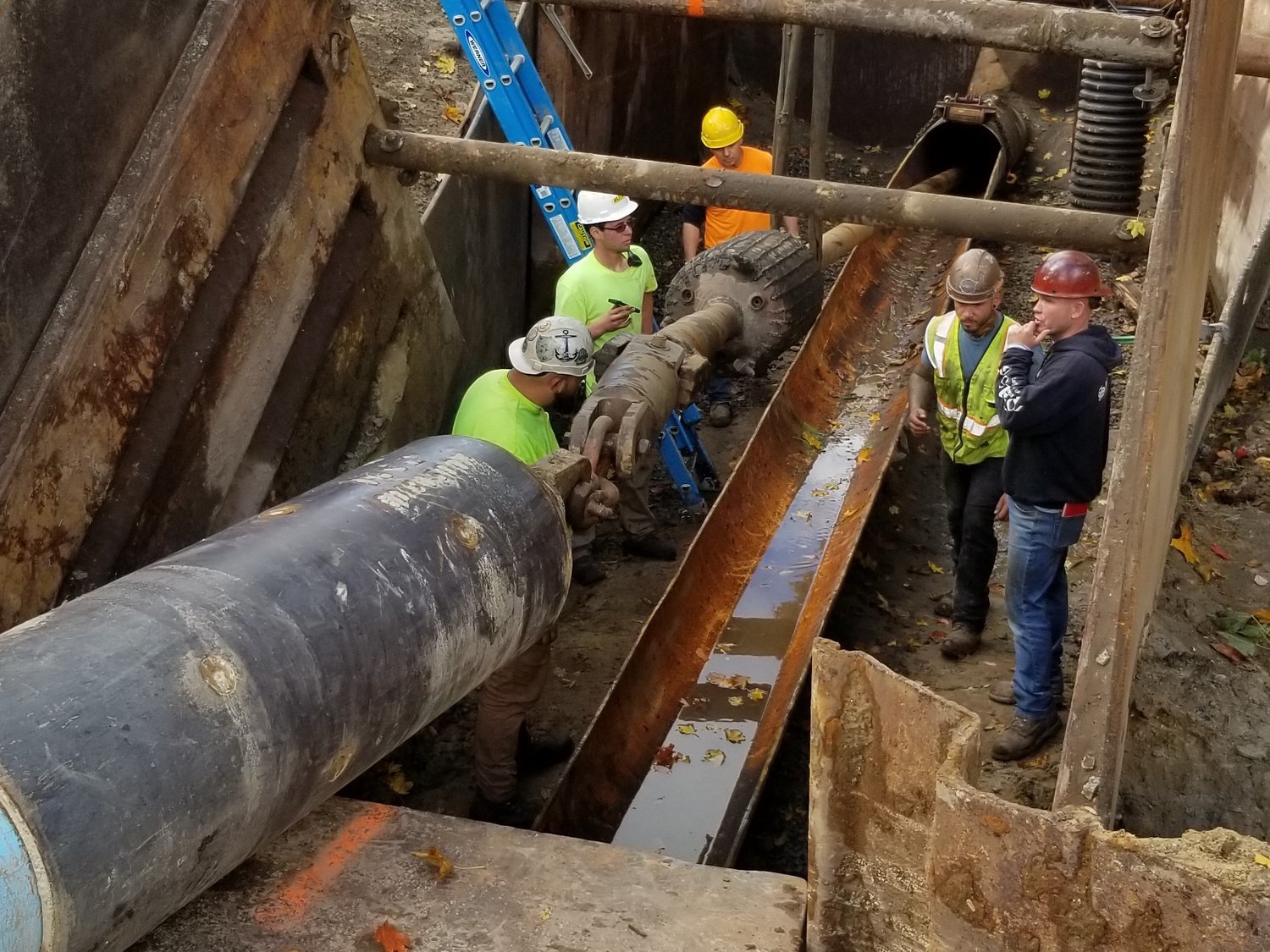 Workers feed the liner through the leaky Cross Bay Pipeline last month.