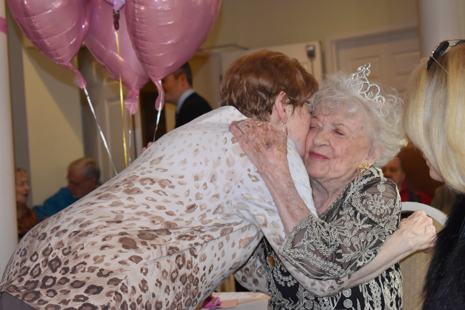 Mary Quinn (right) is greeted by one of her many friends at her 100th birthday party at Franklin Court.