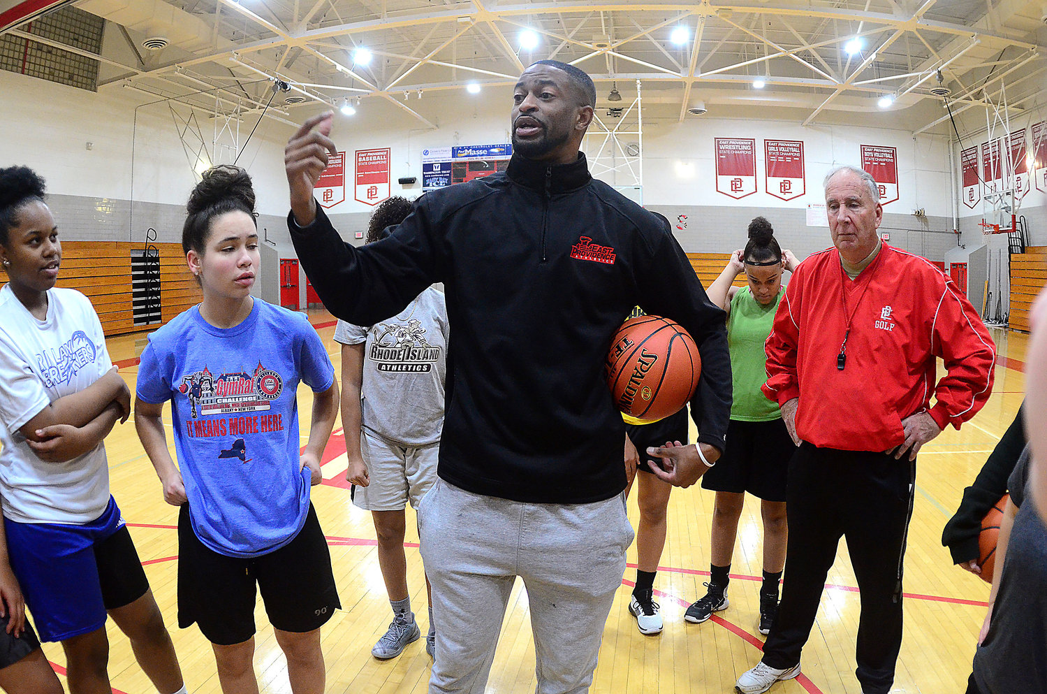 City native and alum Tshombe “Bay” Lambert talks to members of the team before a practice last week when he took over as the new head coach for the East Providence High School girls’ basketball program.