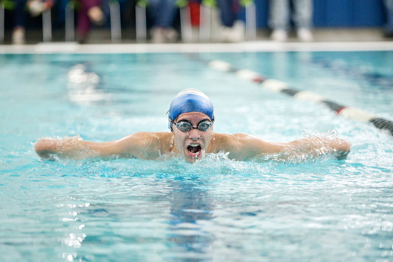 Brandon Nelson takes a big breath while swimming the butterfly portion of the boys’ 200 individual medley race against East Providence High School.