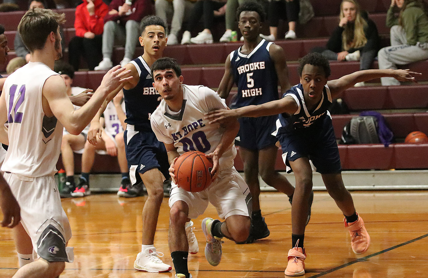 Point guard Xavier Costa looks to drive to the basket with Brooke High players in tow.