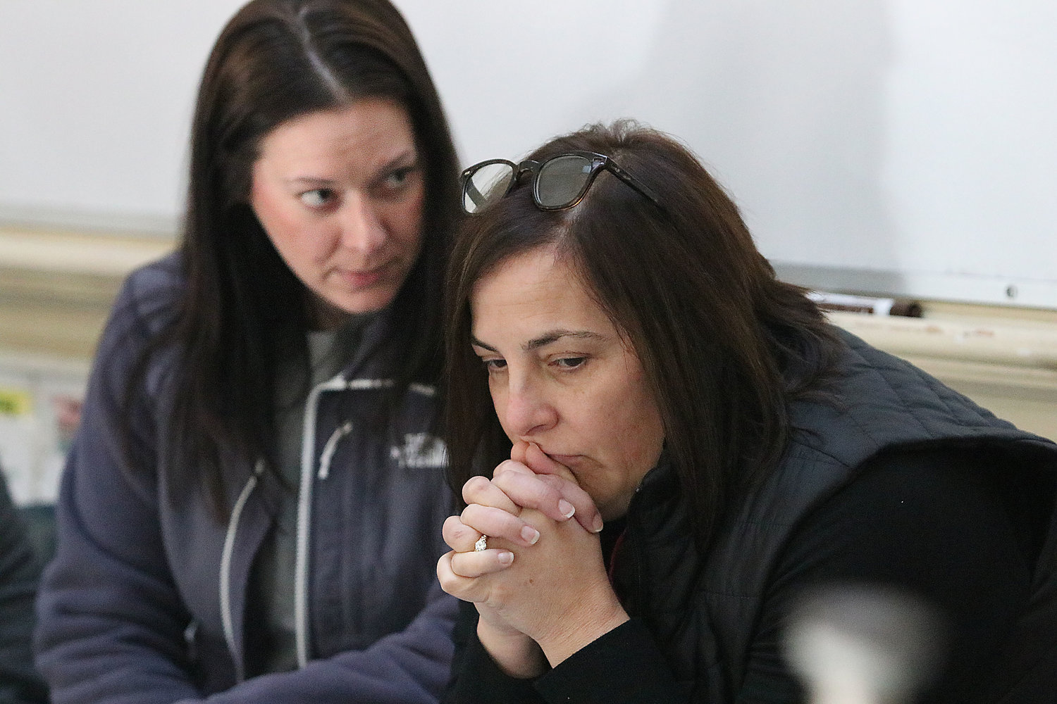 Colt Andrews fourth-grade teachers Jennifer Cotoia (left) and Lori Albuquerque nervously wait and listen for gun shots and banging on classroom doors as an active shooter roams the hallways during a training last Thursday.