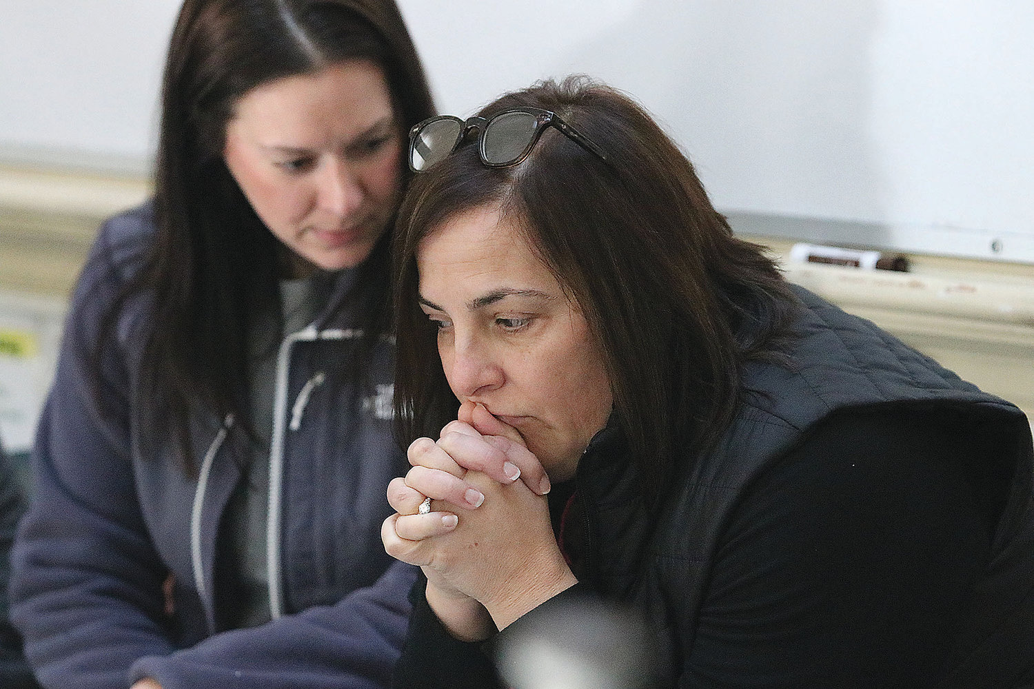 Colt Andrews fourth-grade teachers Jennifer Cotoia (left) and Lori Albuquerque nervously wait and listen for gun shots and banging on classroom doors as an active shooter roams the hallways during a training last Thursday.