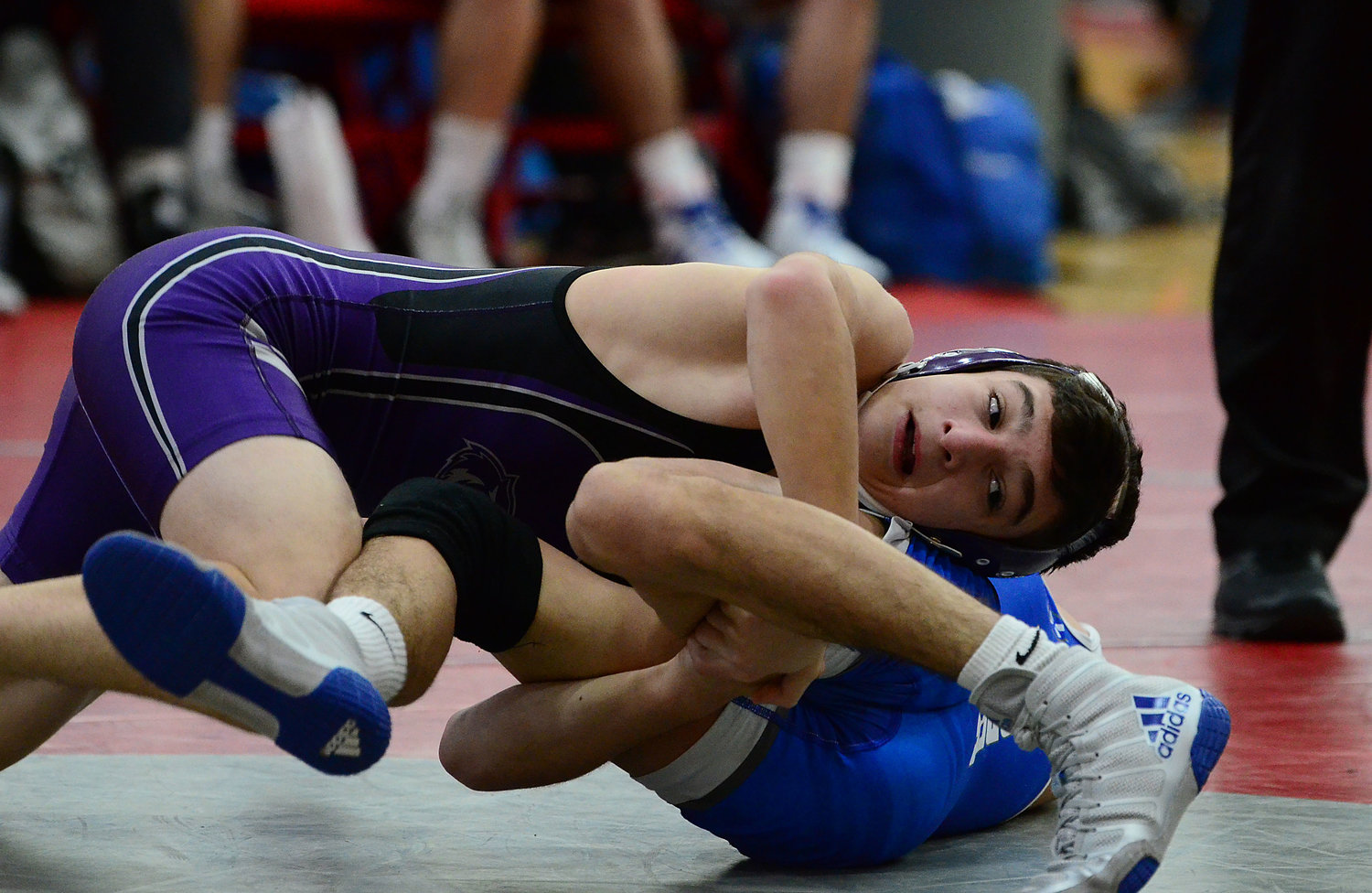 106 pound freshman Carson Correia wraps up the legs of Cumberland’s Corbin Dias during a quad meet at East Providence High School on Monday. Correia went 1-2 during the meet, losing decisions to Dias and to Hope’s Nicholas Torres and winning a decision over Sean Sullivan of East Providence.