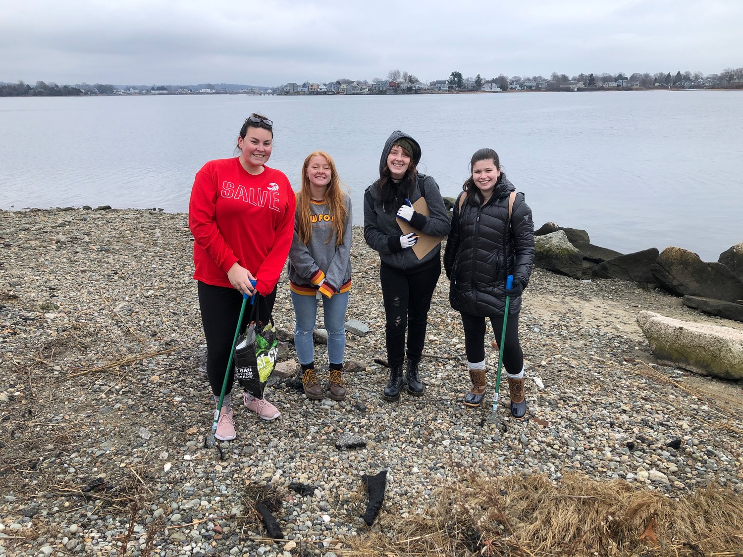 Students from Salve Regina University were among the volunteers who helped out at the Gull Cove cleanup on Saturday.