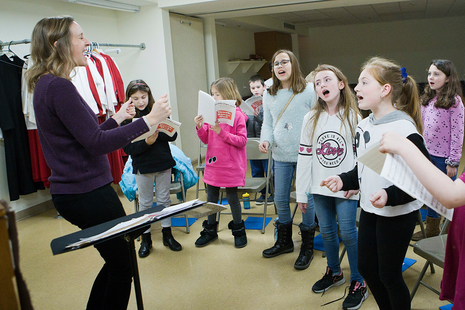 Elizabeth Woodhouse
Newport County Youth Choir director Elizabeth Woodhouse (left) belts out a tune along with choir members during a practice session held at St. Mary's Episcopal Church last week.