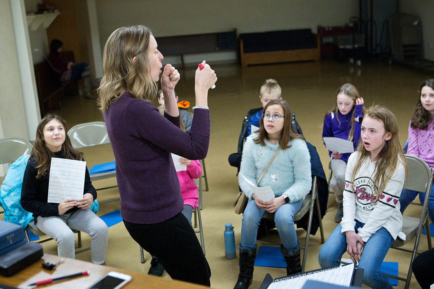Newport County Youth Choir director Elizabeth Woodhouse (left) animates a jazz instrument for students.