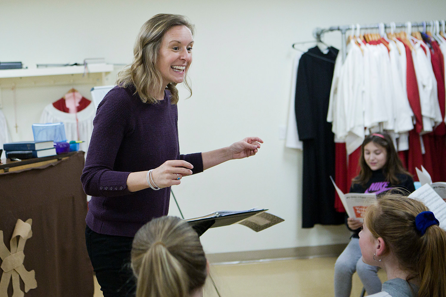 Newport County Youth Choir director Elizabeth Woodhouse sings along with her group during a practice session held at St. Mary's Episcopal Church.