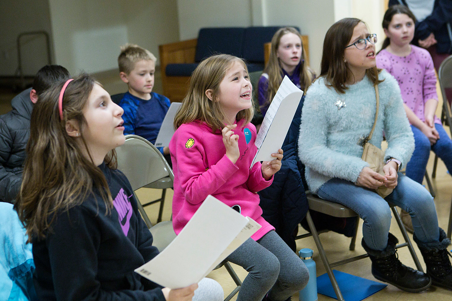 Reagan Applegate of Portsmouth (middle) shows some expression while rehearsing with the Newport County Youth Choir at St. Mary’s Church last week.