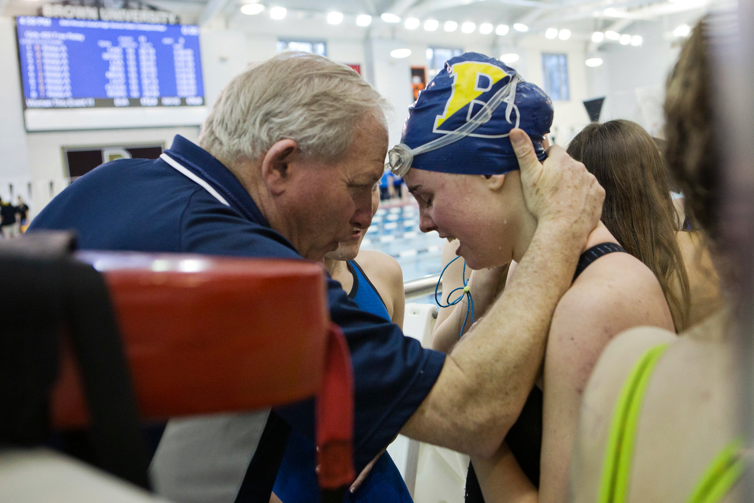 Barrington High School head coach Sandy Gorham and senior Sydni Diehl share a moment after the final event, the 400 free relay, at the state championship meet, Saturday.