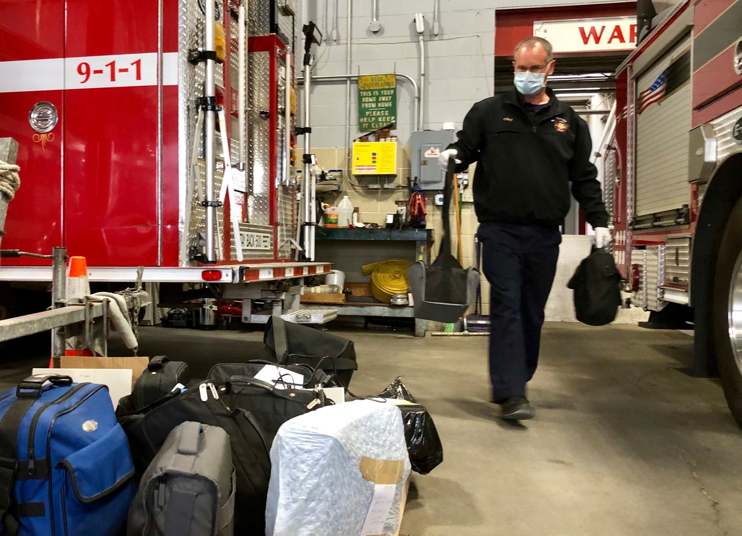 Warren Fire Chief James Sousa loads donated CPAP and BiPAP machines at the fire department Monday morning.